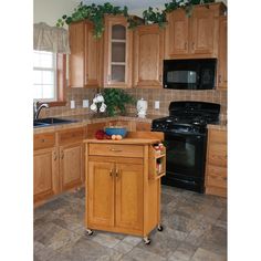 a kitchen with wooden cabinets and an island in the middle, surrounded by tile flooring