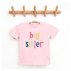 Looking for a cute tee for your kids? We have the perfect Big Sister Colorful graphic tee addition to their closet! Also available in youth tees. Cute Multicolor T-shirt With Name Print, Playful Pink T-shirt With Graphic Print, Playful Pink Graphic Print T-shirt, Playful Short Sleeve T-shirt With Text Print, Playful Pink T-shirt With Text Print, Playful Pink Text Print T-shirt, Family Matching Multicolor Cotton T-shirt, Playful Pink Tops With Name Print, Playful Pink Cotton T-shirt