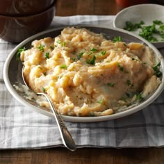 mashed potatoes with parsley in a white bowl