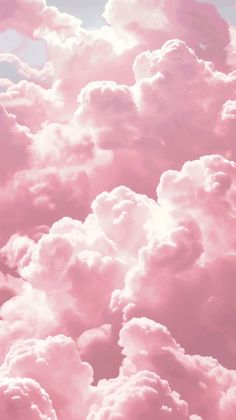 the sky is filled with pink clouds as if it were taken from an airplane window