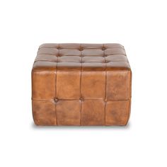 a brown leather foot stool on a white background