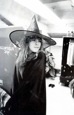 a woman wearing a witches hat in an office