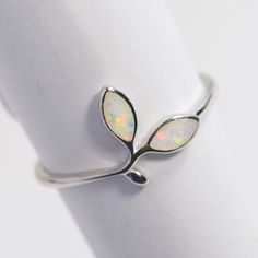 All Sterling Silver items in our shop are stamped 925, lead and nickel free, solid 925 silver, NOT plated or filled. Opal Floral design 925 Sterling Silver Band Lab grown Fire White Opal Band Dainty Stackable Minimalist Simple Thumb ring October Birthstone Simple Silver Band great for every day made with finest quality sterling silver 925.  Opal is the October Birthstone. Wearing Opal is considered by many to brings loyalty, faithfulness and spontaneity in the wearer.  Low profile, very smooth, Hypoallergenic Sterling Silver Jewelry For Promise Ring, Silver Opal Stackable Rings As Gift, Adjustable White Gold Opal Ring, Sterling Silver Open Band Jewelry Gift, Sterling Silver Open Band Jewelry For Gifts, Adjustable White Gold Opal Ring In Fine Jewelry Style, Hallmarked Minimalist Sterling Silver Stackable Rings, Minimalist Hallmarked Stackable Rings In Sterling Silver, Minimalist Hallmarked Stackable Sterling Silver Rings