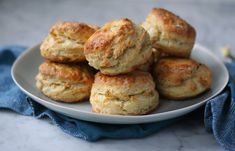 a white plate topped with biscuits on top of a table