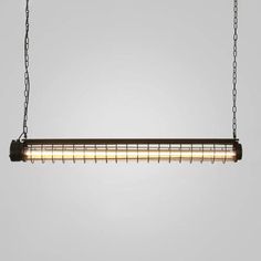 an industrial style light fixture hanging from a chain