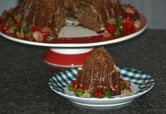 two plates with cakes on them sitting on top of a granite countertop next to each other