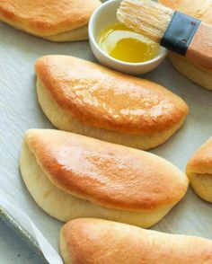 the bread is being prepared and ready to be baked in the oven with a brush