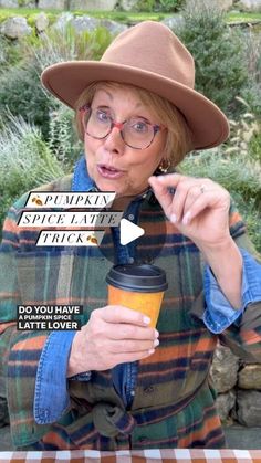 an older woman wearing glasses and a hat holding a coffee cup in her right hand