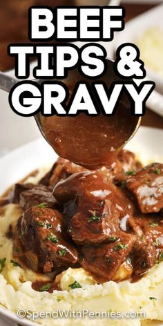 beef tips and gravy is being spooned over mashed potatoes on a white plate