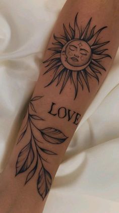 a person with a sun tattoo on their arm and the words love written below it