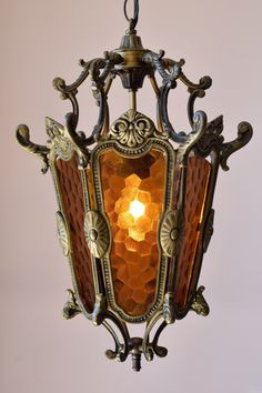 an old fashioned light fixture hanging from the ceiling