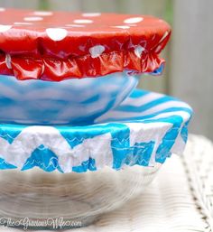 two red, white and blue plates with polka dots on them sitting on a table