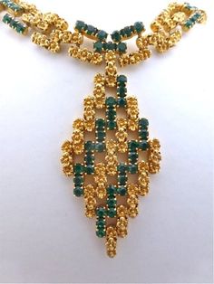 Item oxfj8 Price £125 Circa 1960 Wow this is an absolutely fabuuuuuulous necklace. This piece has a bold profile with vibrant emerald green stones and gold tone flowers, in a link design that moves and adjusts to your neckline when worn. The necklace has a substantial weight and feel and lies flush along your neckline when worn. Overall this is a well made and uniquely designed necklace. The diamond pendant measures approx. 8.5x4.5cm, the necklace measures 31cm extending to 35cm, 1.5cm wide. Formal Green Emerald Necklace With Jewels, Green Hallmarked Emerald Necklace For Wedding, Vintage Gold Emerald Necklace For Formal Occasions, Green Emerald Pendant Necklace For Formal Occasions, Formal Green Emerald Pendant Necklace, Vintage Green Emerald Necklace For Formal Occasions, Antique Green Jewelry For Evening, Green Pendant Jewelry For Evening, Evening Yellow Gold Jewelry With Emerald