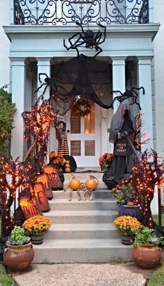 a house decorated for halloween with pumpkins and decorations