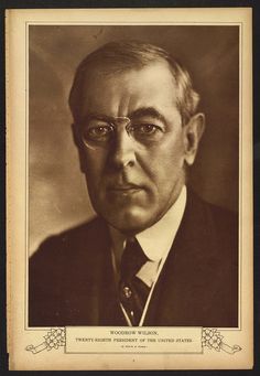 an old black and white photo of a man in glasses with a suit and tie