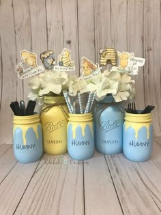 painted mason jars with flowers in them