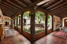 the inside of a house with large windows and wooden doors on both sides of it