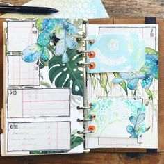 an open planner with butterflies and flowers on it