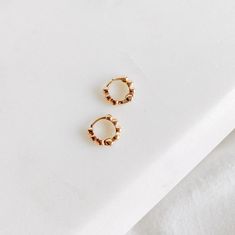 Add a touch of understated elegance with The Mini Dottie Hoops. These delicate hoops are the perfect way to elevate your everyday look with a subtle glimmer. With their tiny, minimalistic design, these hoops provide just the right amount of shine to make a statement while maintaining a light, barely-there charm. The Details - Material: 18K Gold Filled—offering a luxurious gold finish with long-lasting durability and a shine that won’t fade. - Hoop Size: 10mm—small and delicate, providing a refin Simple Tiny Gold Huggie Earrings, Tiny Gold Huggie Earrings Simple Style, Delicate Gold Small Hoop Huggie Earrings, Earrings Collection Gold, Necklaces Simple, Unique Pendant Necklace, D F, Jewelry Essentials, Gold Filled Ring