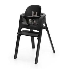 a black high chair that is on top of a white background with the seat up