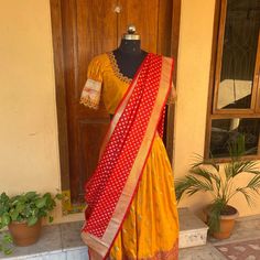 Wedding lehenga choli/ lehenga set with dupatta / teens lehenga/ bridal lehenga/ kids lehenga Indian banarasi half saree / crop top lehenga/ lehenga USA / Langa voni / voggish / yellow red lehenga / pattu pavadai Here is a beautiful and traditional Indian banarasi katan silk lehenga in mustard yellow color with red color border combination is a stunning piece for your upcoming parties!! It's a 3 piece set that includes skirt , hand embroidered blouse and red banarasi dupatta, please find the det Traditional Drape Gown With Pallu In Dola Silk, Diwali Gown With Unstitched Dola Silk Blouse, Festive Unstitched Lehenga With Blouse, Unstitched Lehenga With Blouse For Festive Season, Art Silk Saree Gown With Unstitched Blouse, Festive Lehenga With Zari Work In Traditional Drape, Semi-stitched Dola Silk Lehenga For Festive Occasions, Designer Choli With Self Design And Traditional Drape, Traditional Drape Chanderi Lehenga For Festive Occasions