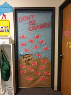 the door to an office is decorated with pink and blue paper machs that read don't be crabby