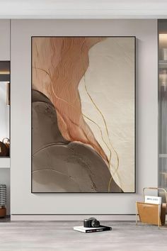 an abstract painting hangs on the wall in a modern living room