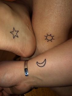 two people with matching tattoos on their feet, one has a sun and the other has a moon