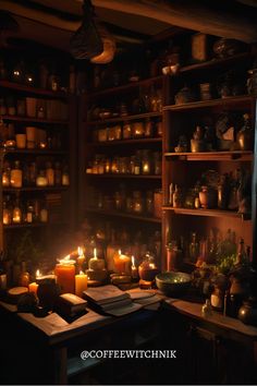 candles are lit in front of bookshelves with jars on the shelves behind them