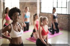 a group of women doing yoga in a gym