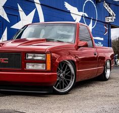 a red truck parked in front of a building