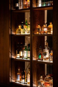 the shelves are filled with different types of liquor