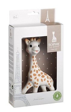 a white and orange giraffe toy in a cardboard box with the eiffel tower in the background