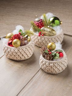 three baskets filled with ornaments on top of a wooden floor