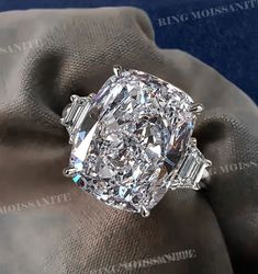 a large diamond ring sitting on top of a glove