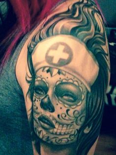 a woman's half sleeve with a skull and cross tattoo on her left arm