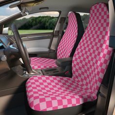 a pink and white checkered car seat cover in the back of a vehicle,