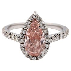 2.13ct Pear-Shaped Pink Diamond Ringent  This elegant 2.13ct pear-shaped pink diamond ring, set in a two-tone 18K gold band with 0.57ctw of round brilliant diamonds, is GIA certified and weighs 31.4 grams. Resizable and designed for timeless beauty. Metal Color: Two-Tone Metal Purity: 18K Stone: Diamond (2.13ctw) Main Stone Shape: Pear Clarity: VS2 Secondary Stones: Diamond (0.57ctw) Secondary Stone Cut: Round Brilliant  Ring Size: 7 Includes: GIA Certificate  Necklace: 13.51ctw  Necklace Stones: Pink & White Diamonds Total Gram Weight: 31.4g  Resizable: Yes Necklace Stones, Brilliant Ring, Gia Certificate, Pink Diamond Ring, Pear Shaped Ring, Diamond Ring Set, Stone Cuts, Gigi Hadid, Pink Diamond