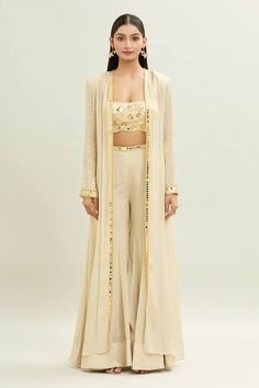 Ivory padded blouse with acrylic embroidery and scalloped hem. Paired with a sharara and longline embroidered cape jacket. - Aza Fashions Elegant Cream Choli For Festive Occasions, Elegant Cream Choli For Festive Season, Elegant Cream Choli For Designer Wear, Cream Choli For Eid, Elegant Beige Choli With Sheer Dupatta, Elegant Beige Choli For Designer Wear, Bollywood Style Beige Sets With Sheer Dupatta, Elegant Beige Designer Choli, Festive Beige Palazzo Set For Reception