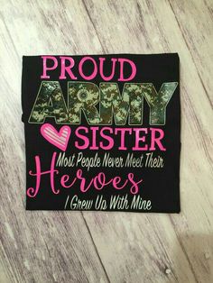 a t - shirt with the words proud army sister and hearts on it, sitting on a wooden surface