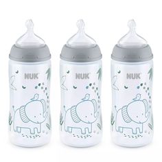 three baby bottles with elephants on them sitting next to each other