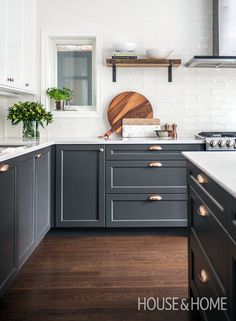 a kitchen with gray cabinets and white walls