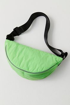 a green fanny bag hanging on the wall