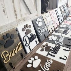 a table topped with lots of different types of dog tags and magnets on top of wooden boards