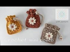 three crocheted bags with flowers on them