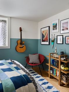 a bed room with a guitar on the wall