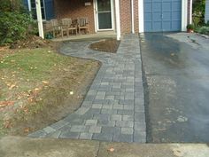 a brick driveway in front of a house