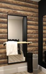 a bathroom with a mirror, towel rack and toilet paper dispenser in it