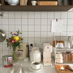 the kitchen counter is clean and ready to be used as a coffee bar or breakfast bar