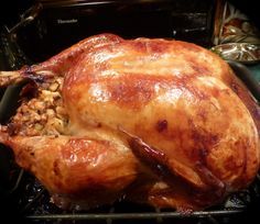 a roasted turkey is sitting in a roasting pan